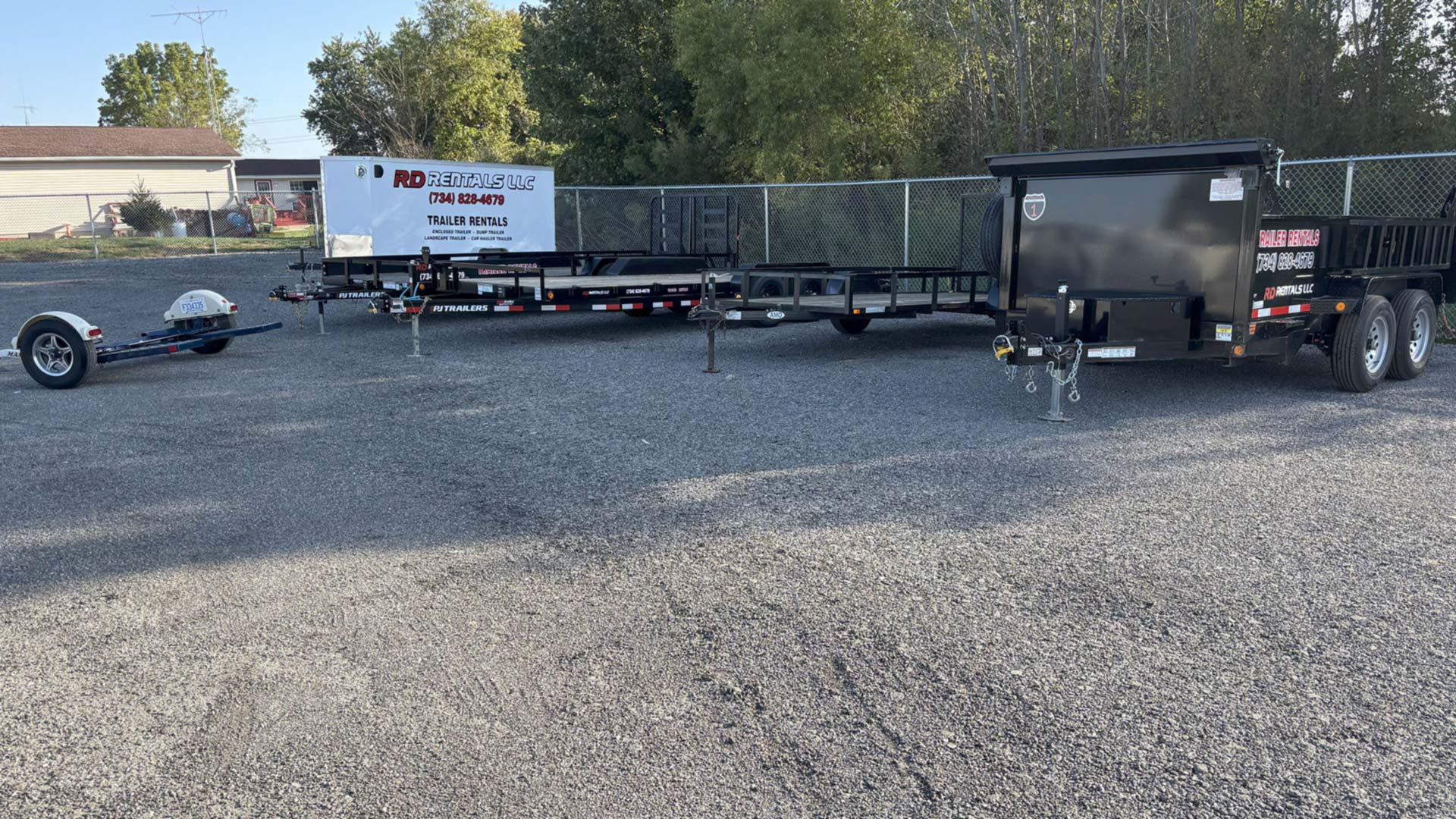 RD Trailer Rentals yard in Dundee Michigan showing car hauler landscape dump trailers for rent